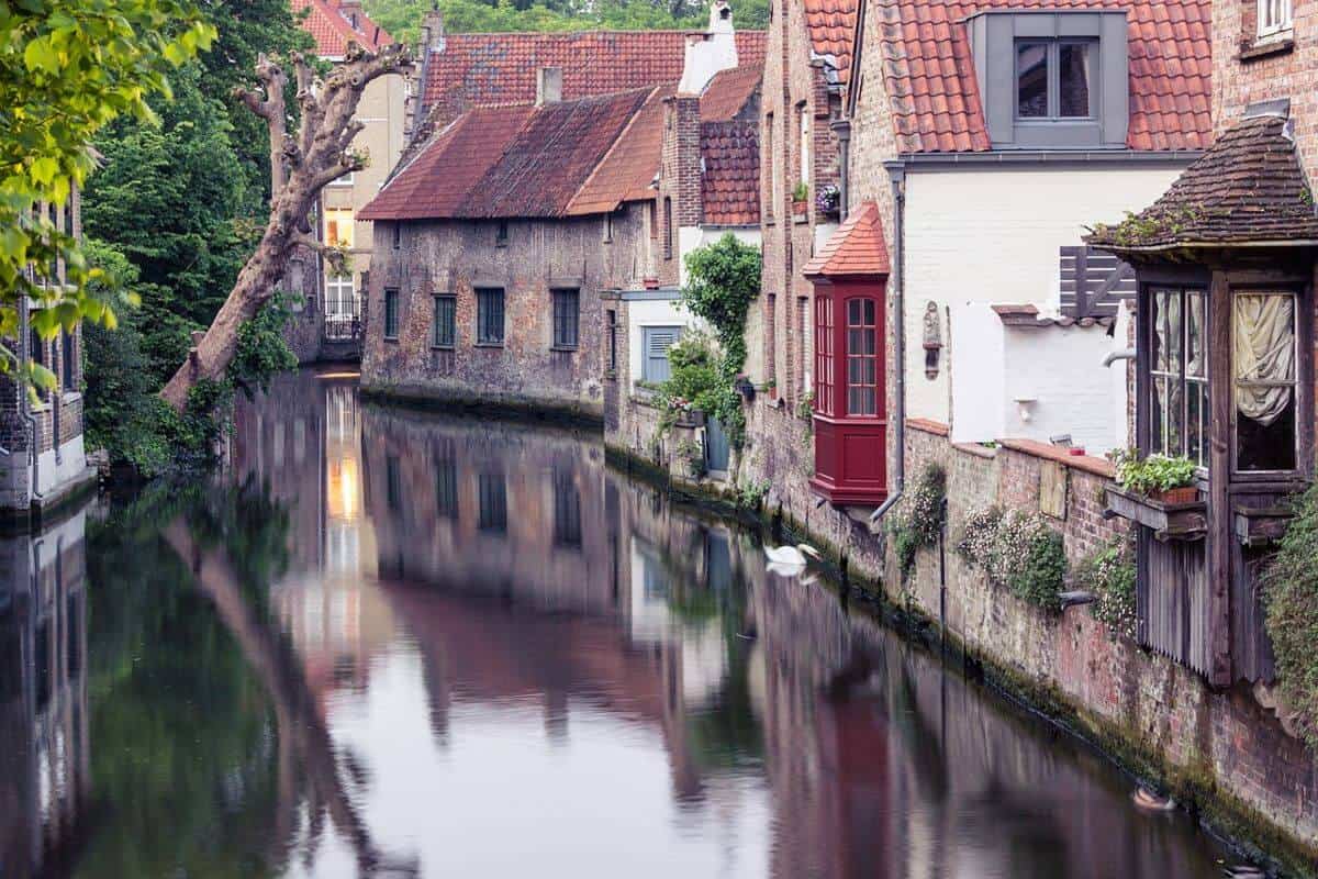 Historic houses reflected in a canal in Bruges, Belgium