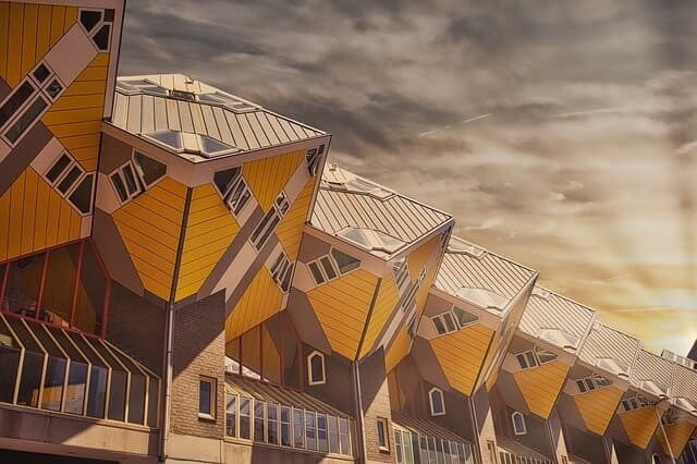 Rotterdam’s tilted yellow Cube Houses beneath a cloudy sky