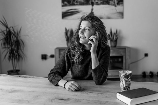 Woman sitting at home talking on the phone