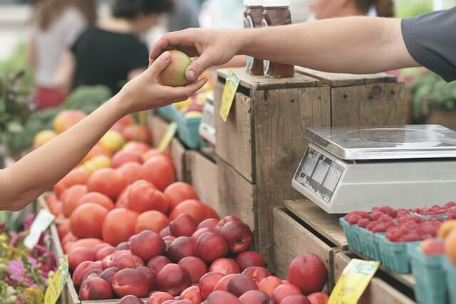 Buying fresh food at a local market while travelling