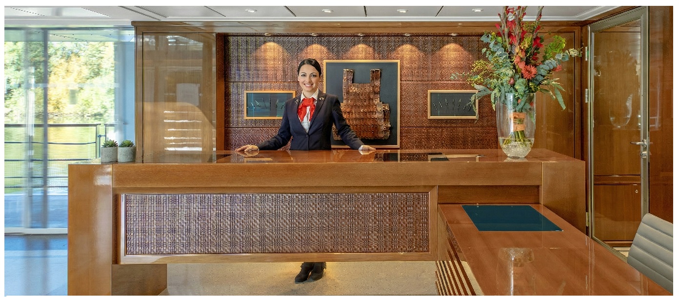 A Viking cruise guest services area with calm, elegant ship atmosphere