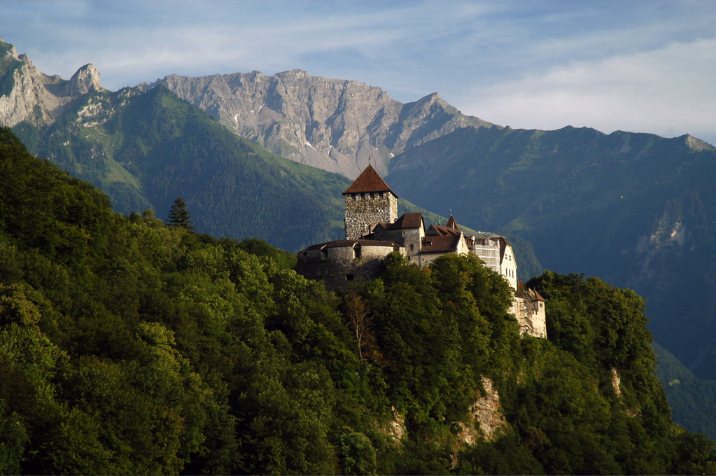 Liechtenstein travel scene: castle-on-a-hill energy, Alpine air, and a calm valley rhythm