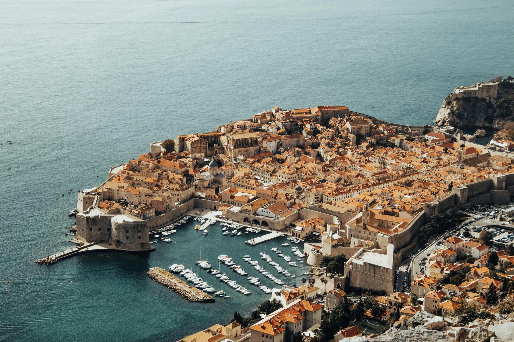Croatia travel scene: aerial view of Dubrovnik's historic old town with terracotta roofs and ancient walls along the Adriatic Sea