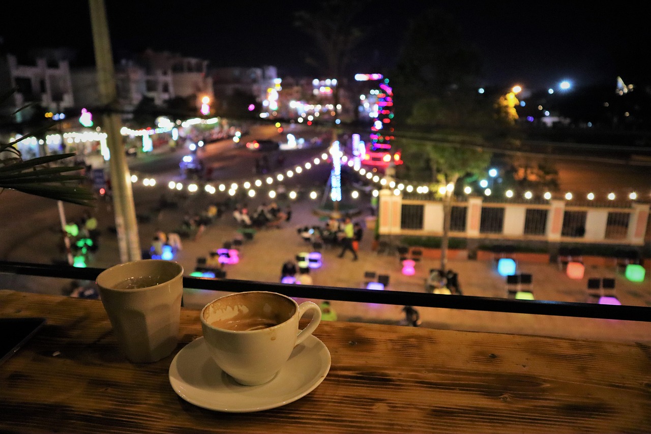 An Eastern European old town square with warm lights and café seating