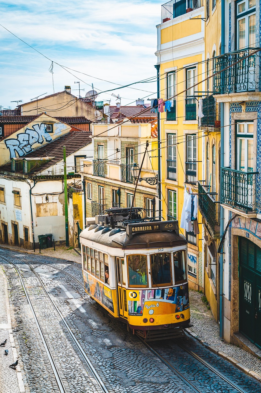 Portugal travel scene: Lisbon's yellow tram on cobblestone streets with colorful buildings
