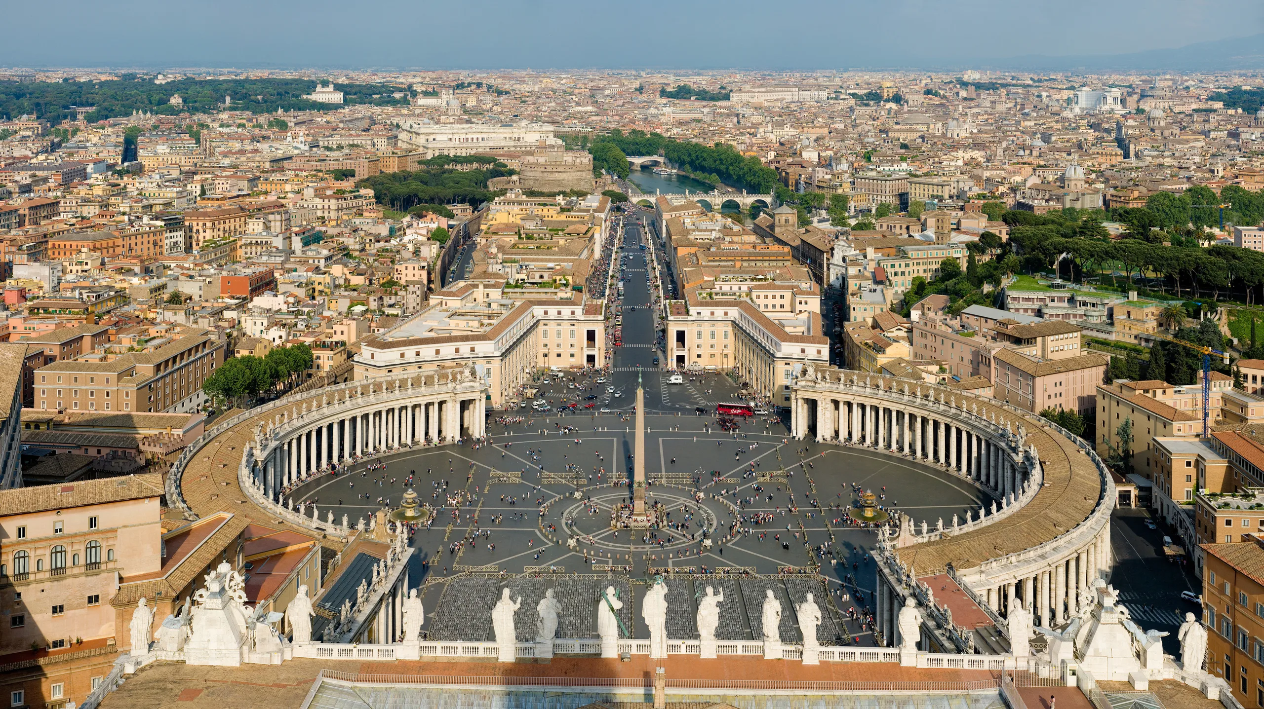 Vatican City travel scene: St. Peter's Square with Bernini's colonnade and basilica dome at golden hour