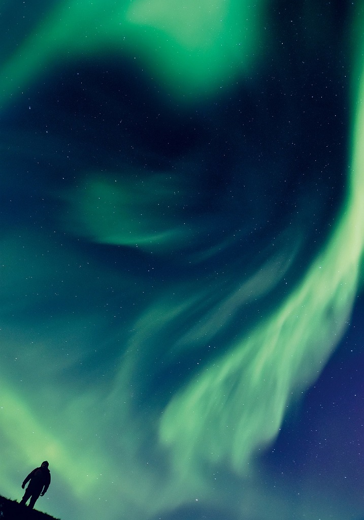 Aurora borealis over a Northern European landscape