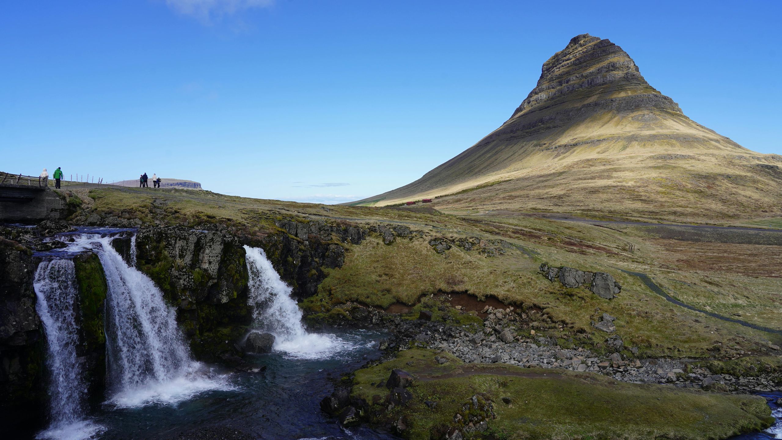 Iceland travel scene: dramatic landscape with mountains, waterfalls, and volcanic terrain