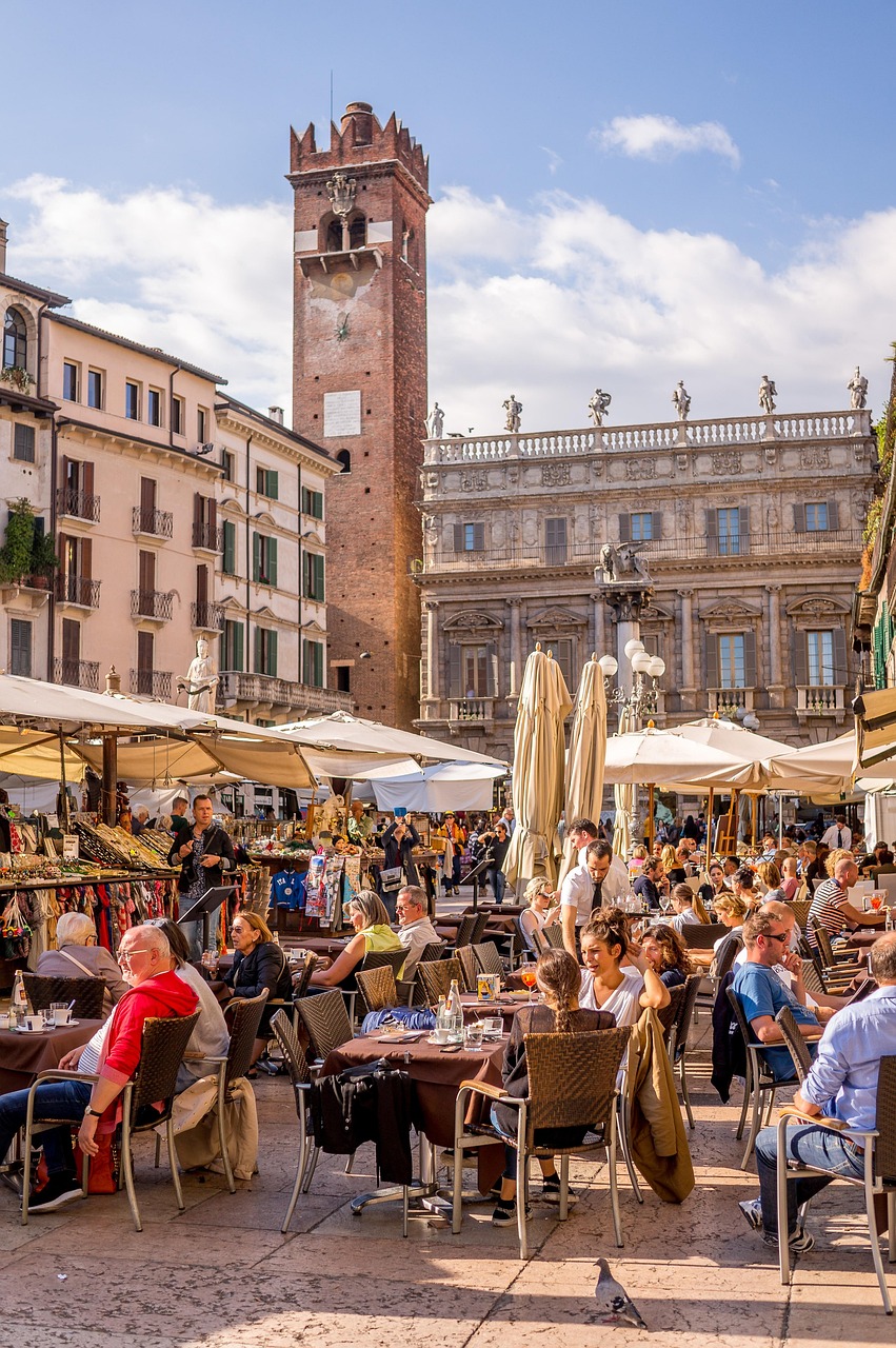 A busy Southern European market street with locals shopping