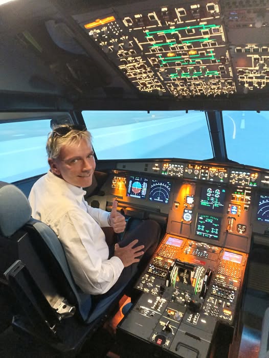 Rob Wheatley seated in an Airbus cockpit while learning how commercial aircraft operate