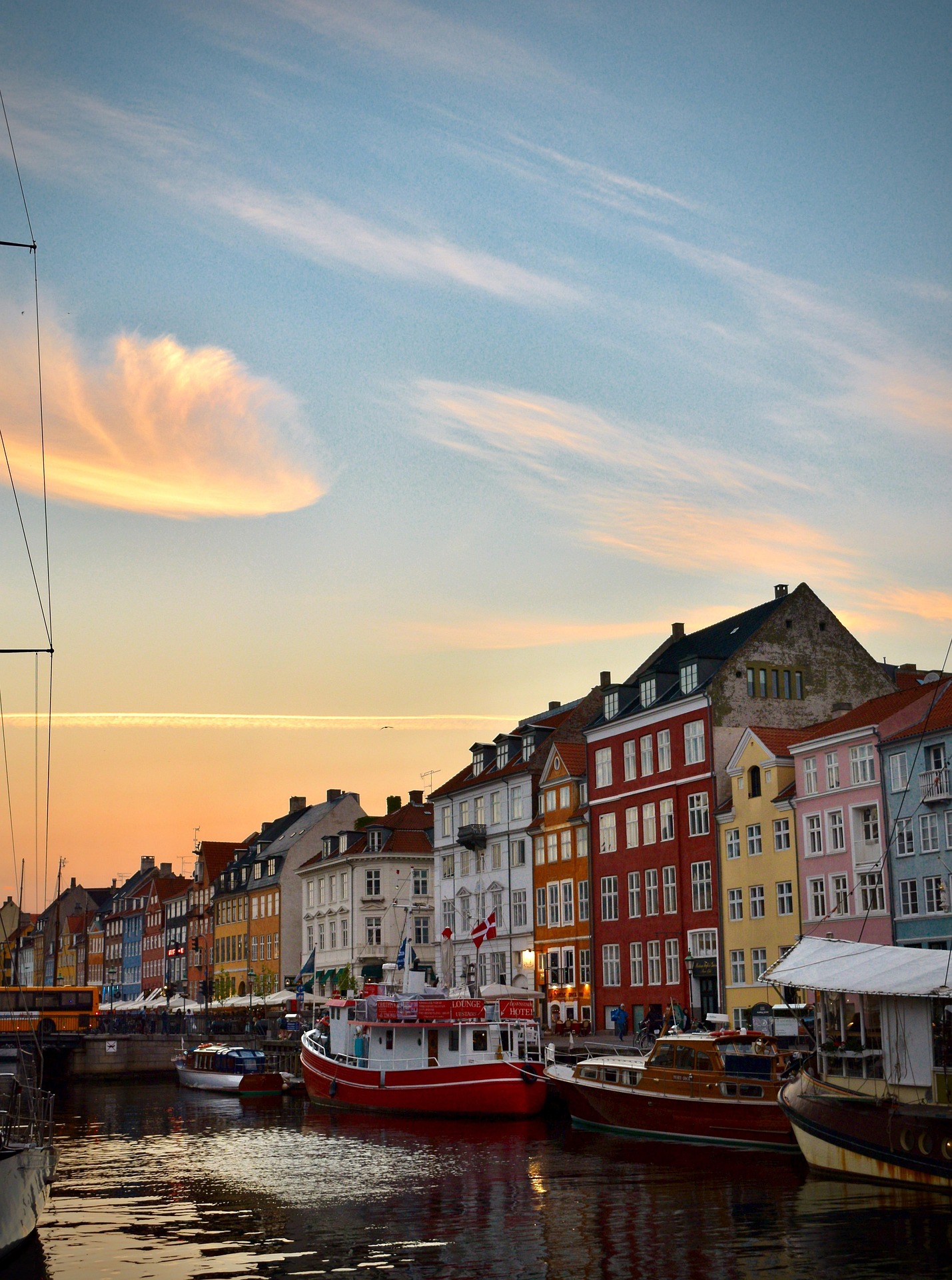 Colorful waterfront buildings and moored boats at Nyhavn in the evening light
