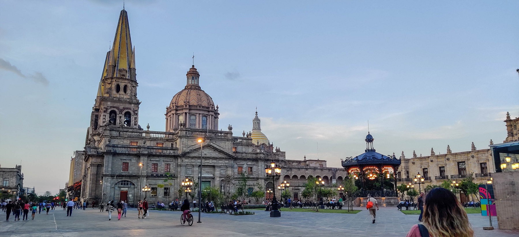 Historic buildings and an illuminated bandstand in Guadalajara at dusk