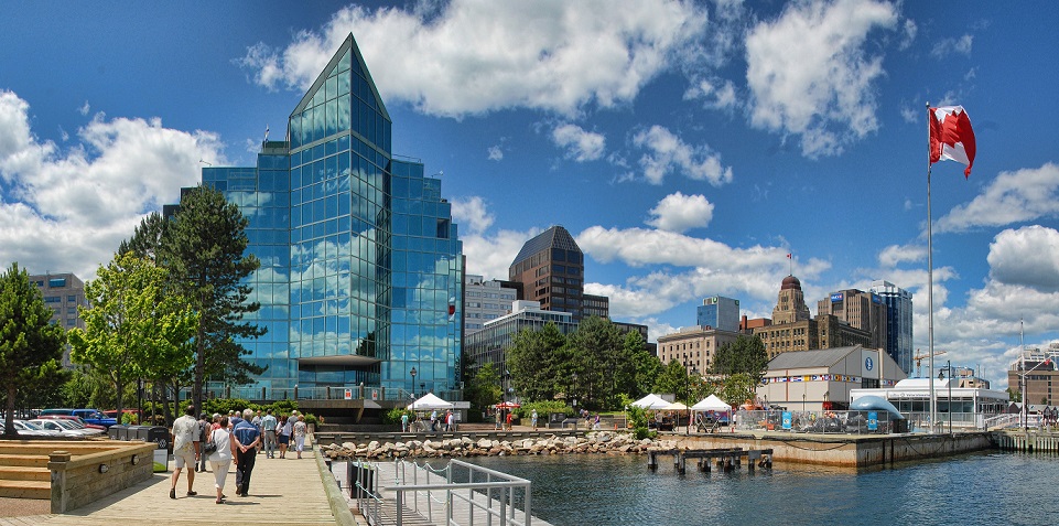 Halifax waterfront with pedestrians and a Canadian flag