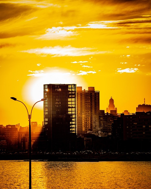 Montevideo skyline and waterfront silhouetted against a golden sunset in Uruguay