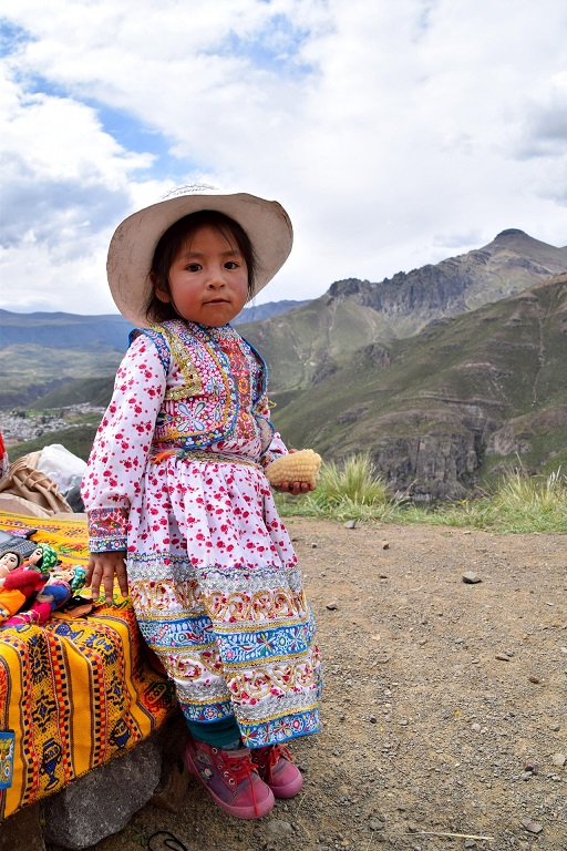 Girl in a colourful embroidered dress and hat in Peru’s Andean highlands