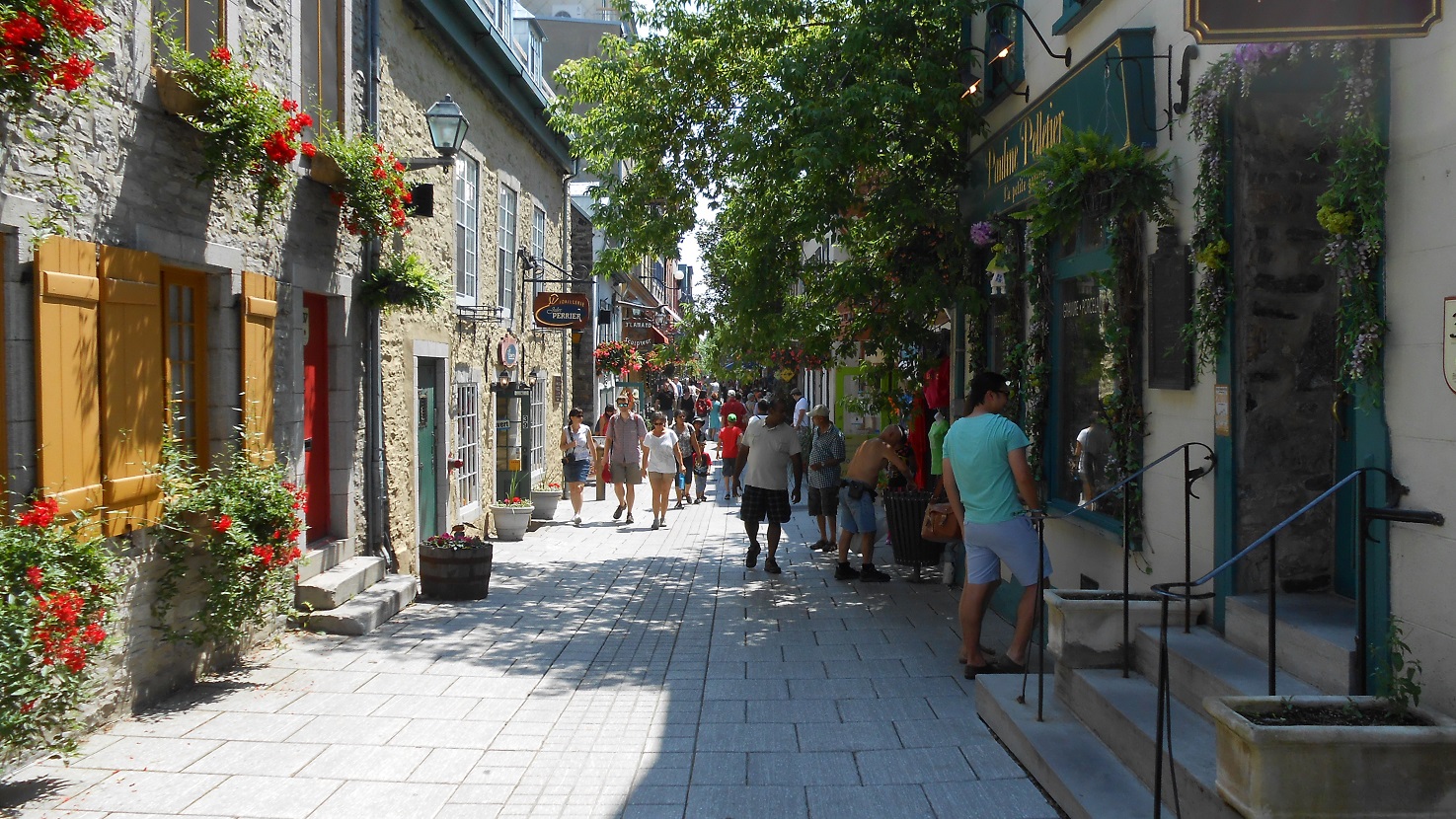 Pedestrians along a flower-lined street in Québec City