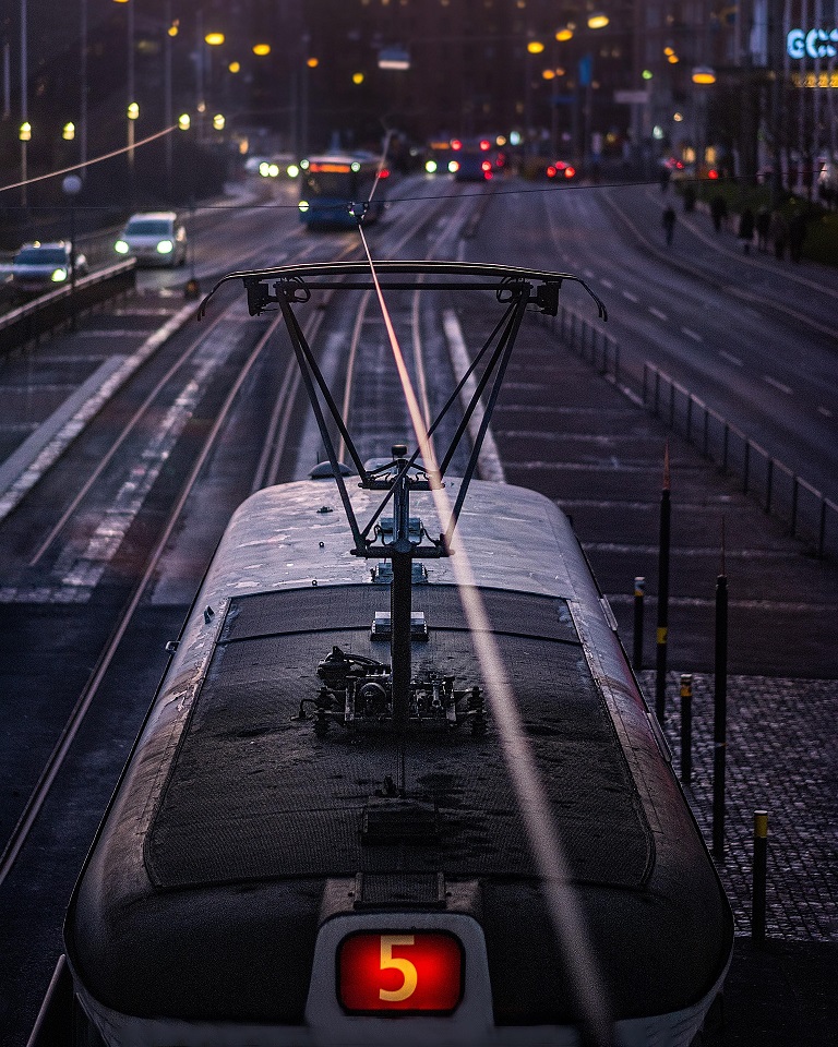 A tram on an illuminated city street in Sweden