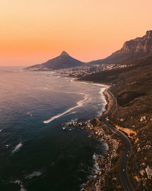 Cape Town’s Atlantic coast in evening light with Lion’s Head in the distance