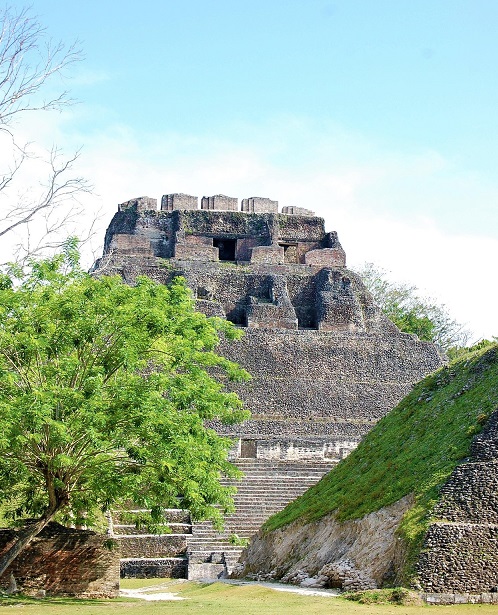 Ancient Maya stone temple and steps surrounded by greenery in Belize