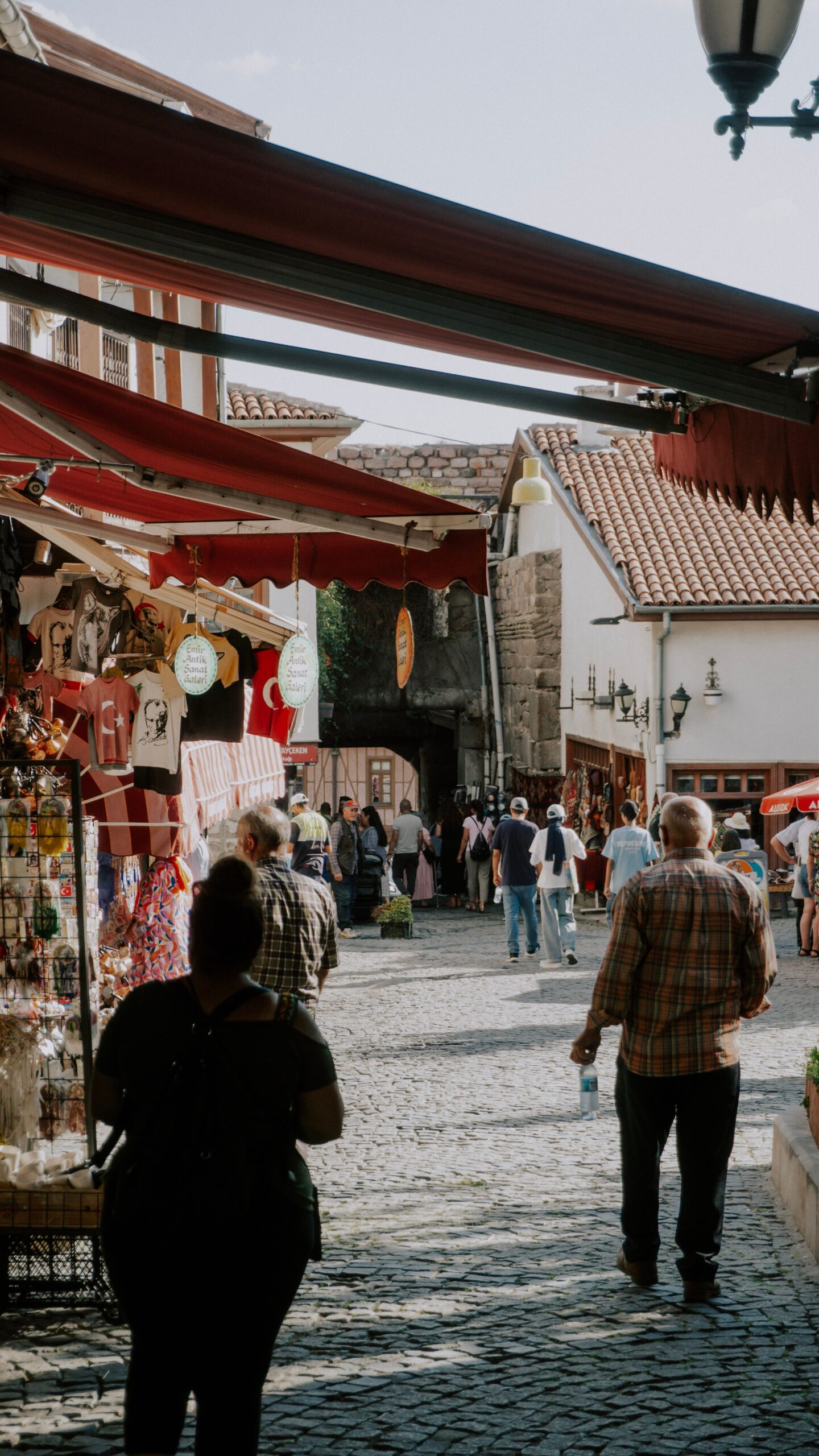 Travellers walking through a local market street, one way to discover a nearby destination