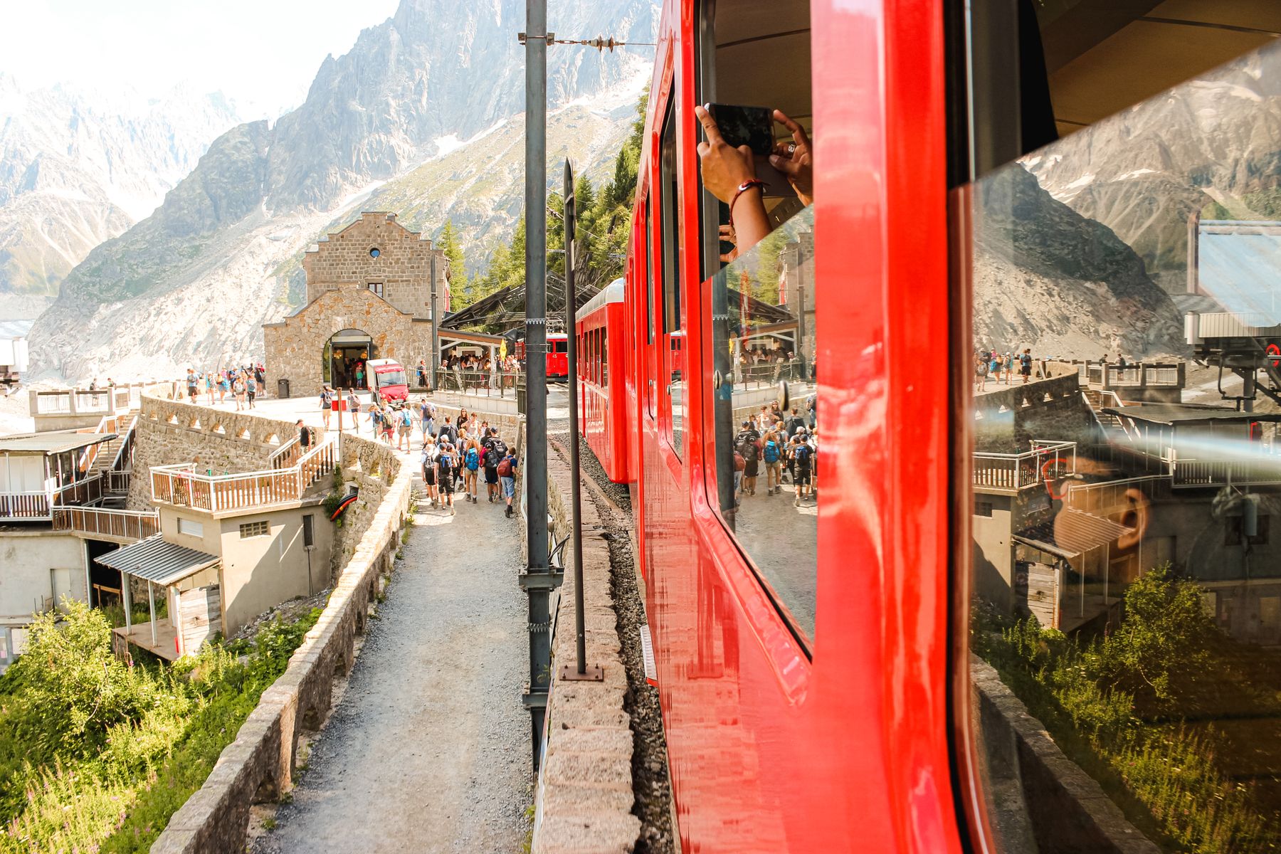 Red mountain train beside a station platform in Chamonix