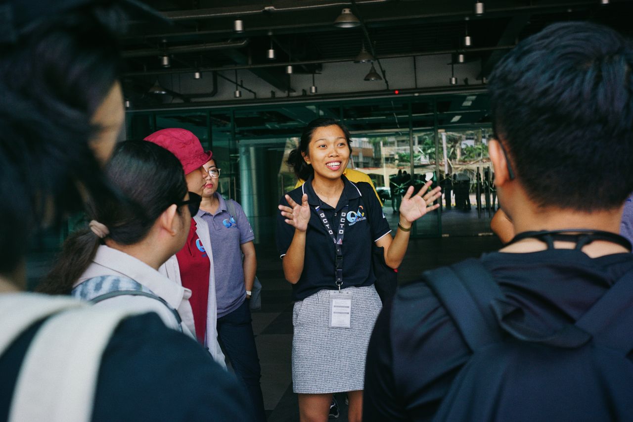 Guide gesturing while a group listens outdoors