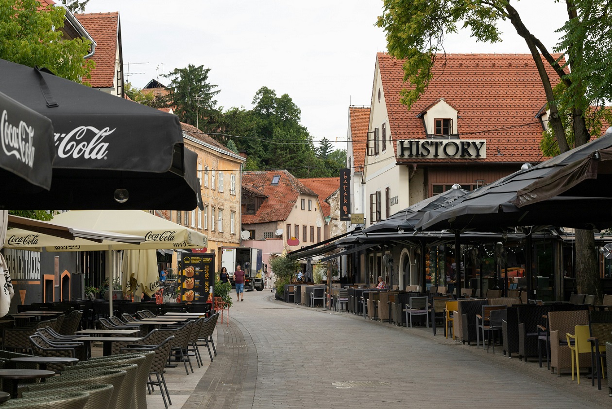 Quiet Zagreb street in the morning with café tables, reflecting a slower travel rhythm