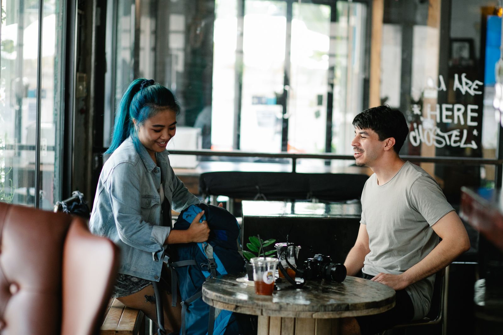 Two travellers sharing a conversation at a café table